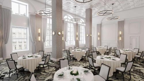 a banquet hall with tables and chairs and chandeliers at Hotel Flor Tampa Downtown, Tapestry Collection By Hilton in Tampa