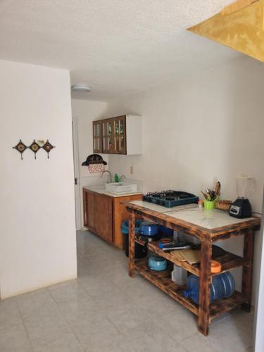 a kitchen with a counter and a table in it at Casa Amarilla in Zihuatanejo