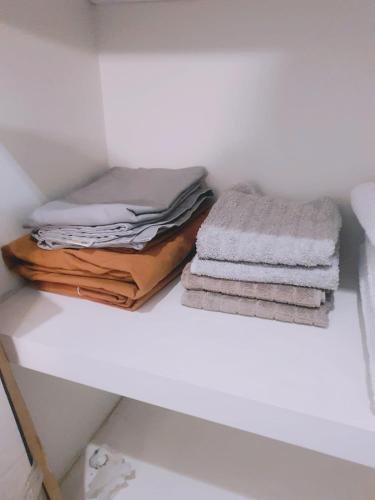 a pile of towels sitting on top of a shelf at On Paseo de la Reforma, great location, luxurious, pool, gym in Mexico City