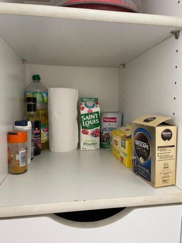 a shelf with toilet paper and a box on it at JUAN LES PINS, T2 Cosy et confortable, avec PARKING en sous-sol, proche plages et commerces in Antibes