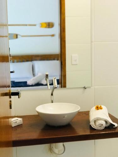 a bathroom with a bowl sink and a mirror at Canto do Una- hospedagem in Barra do Una