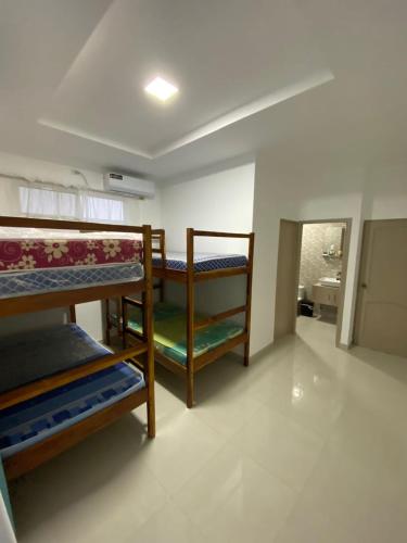 a room with three bunk beds in a room at Casa salinas in Santa Elena