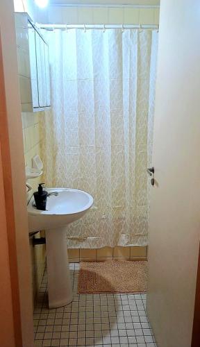 a bathroom with a sink and a shower curtain at Apartamento IdeaL Independencia VI in Mendoza