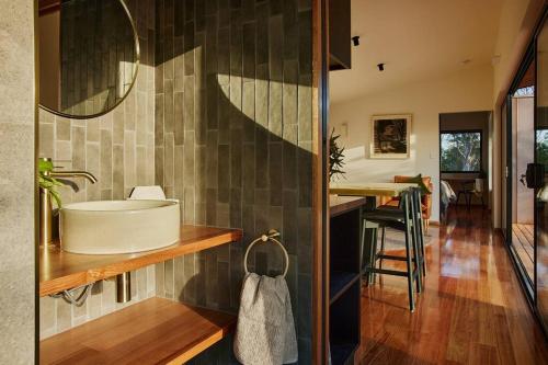 a bathroom with a tub and a sink at Arden Retreat - The Croft at Richmond in Richmond