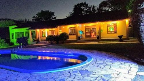 a house with a swimming pool at night at Pousada do sobrado in Bagé