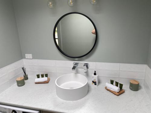 a bathroom with a sink and a mirror at 3 Bedroom Holiday house in Halls Gap