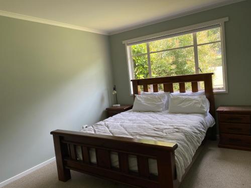 a bedroom with a large bed and a window at 3 Bedroom Holiday house in Halls Gap