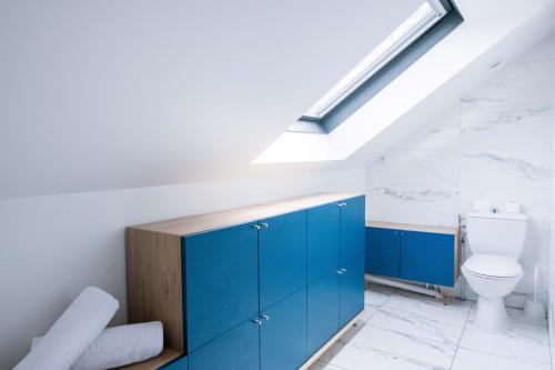 uma casa de banho com armários azuis e um WC em Le Champs-Elysees - Cité universitaire Paris 14 em Gentilly