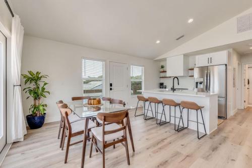 a kitchen with a table and chairs and a counter at Bright New Beach House with In- Law Suite -- 2 blocks to beach! in St. Augustine