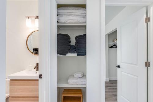 a bathroom with a closet with towels and a sink at Bright New Beach House with In- Law Suite -- 2 blocks to beach! in St. Augustine