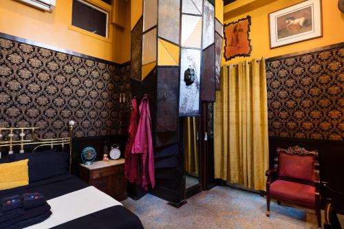 a bedroom with a bed and a chair at The Rosemary in Los Angeles
