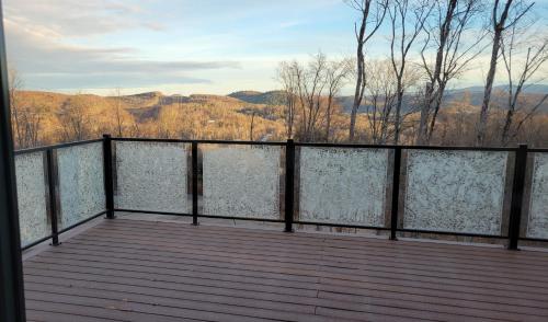 a balcony with a view of the mountains at The Golden View - Luxury Cottage in La Conception