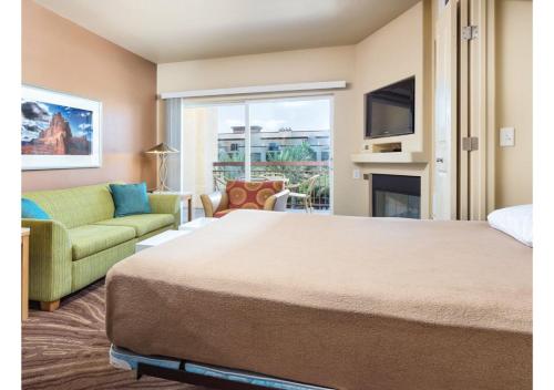 a bedroom with a bed and a couch and a fireplace at Deluxe 3-BR Condo - Lazy River Summer Fun - Special Offer Now! in Las Vegas