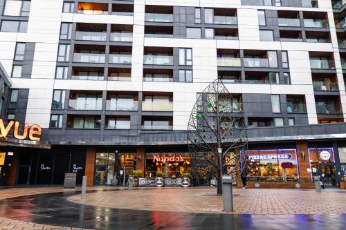 a tall building with a tree in front of it at Preciousluxurysuit in Bromley