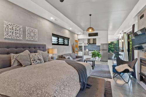a bedroom with a bed and a living room at La Rochér Eco Retreat in Stokers Siding