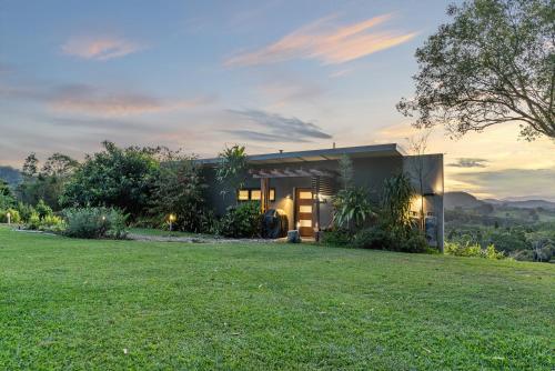 a house with a lawn in front of it at La Rochér Eco Retreat in Stokers Siding