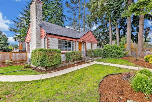 a home with a garden and a house at Remodeled Home Fenced Yard Outdoor Fireplace in Seattle