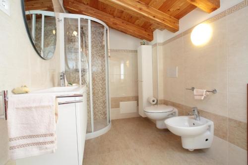 a bathroom with a toilet and a sink and a shower at Albergo Diffuso Polcenigo D. Brolo in Polcenigo