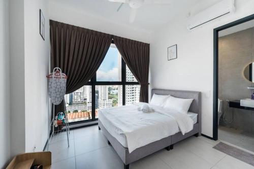 a bedroom with a bed and a large window at NEW Infinity Pool Seaview Urban Suite #2Carparks #2BR in Jelutong