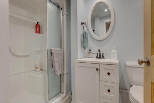 a bathroom with a shower and a sink and a mirror at Chalet dans les arbres. 3 ch. /trees house 3bdr in Lac Sainte-Marie