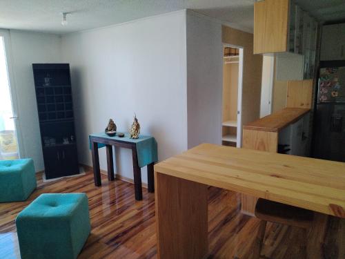 a kitchen with a table and a dining room at Departamento Amoblado in Quilpué