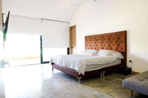 a bedroom with a large bed and a large window at Luxury Villa Cerca Cali - Jamundi in Jamundí