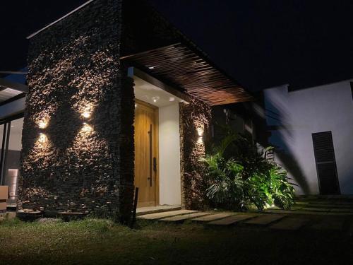 a front door of a house at night at Luxury Villa 15 min Cali - Private Pool in Jamundí