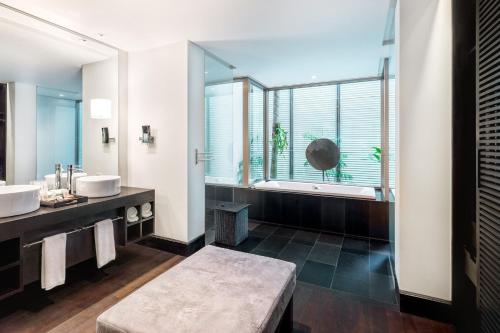 a bathroom with two sinks and a large window at Twinpalms Phuket in Surin Beach