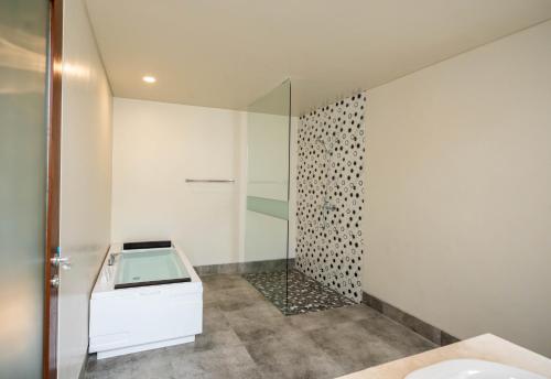 a bathroom with a glass shower and a toilet at Shankara Munduk Bali in Munduk