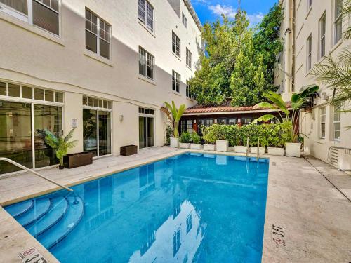 a swimming pool in front of a building at Park Place South of Fifth in Miami Beach
