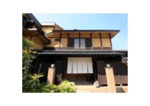 a house with a white window and a building at Saikatei Jidaiya - Vacation STAY 96435v in Kaminoyama