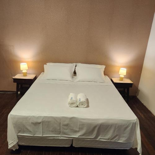 a bedroom with a bed with two shoes on it at CASA IMPERIAL HOTEL POUSADA in São Luís