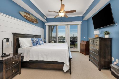 a bedroom with a bed and a flat screen tv at Marina Retreat in Saint Simons Island
