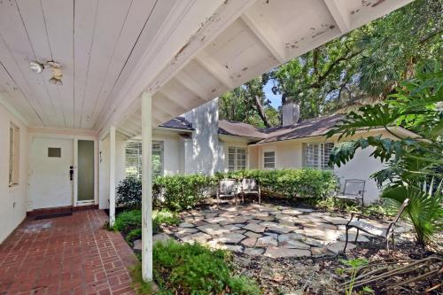 a porch of a house with a white roof at The Pink House in Saint Simons Island