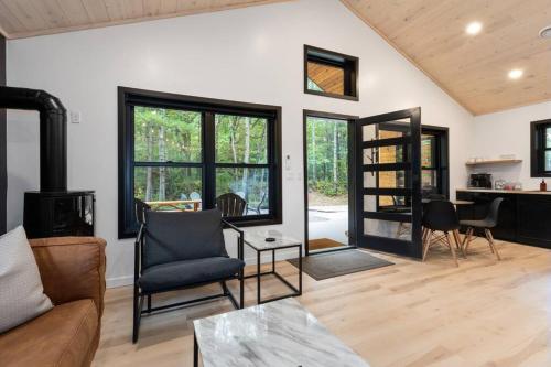 a living room with a couch and a table at Cuyuna Adventure Cabin: Solo Stove - On Bike Trail in Crosby