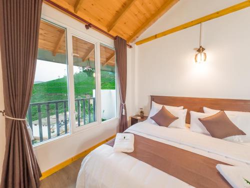 a bedroom with a bed and a large window at The Mount View Single Tree Hotel in Nuwara Eliya