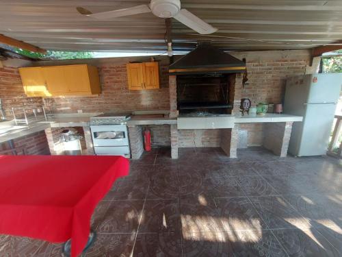 a kitchen with a white counter and a red stool at Casa Niwa koi Entre Peces en Paine in Paine