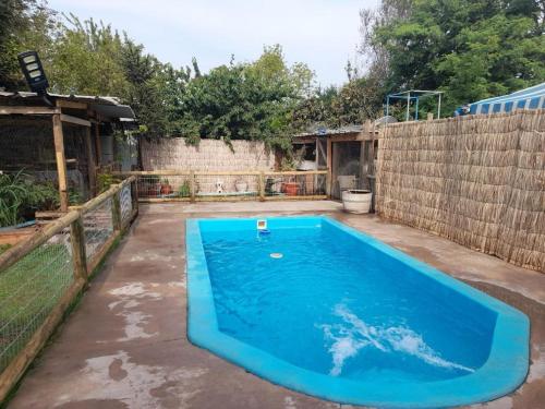 a large blue swimming pool in a yard at Casa Niwa koi Entre Peces en Paine in Paine