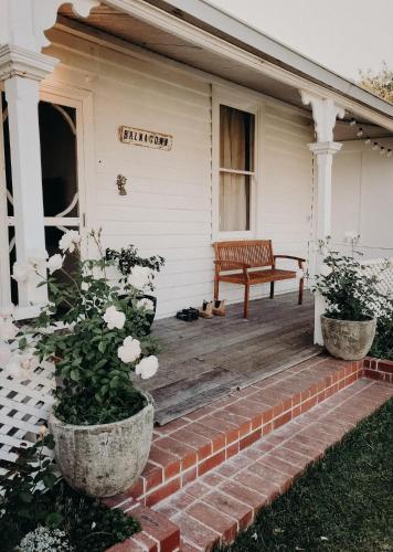 a bench sitting on the front porch of a house at Balnagown in Albany