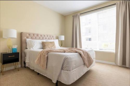 a bedroom with a large bed with a large window at Lux Playa Vista 2 BDRM Condo in Los Angeles