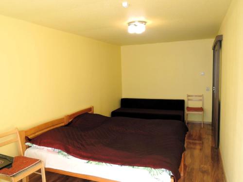 a bedroom with a bed and a couch in it at Holiday home in a quiet location in Borzyslawiec 