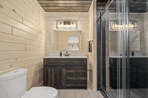 a bathroom with a toilet and a sink and a shower at Remodeled* Sleeps 7, Fire Pit, Indoor Bike Storage in Crosby