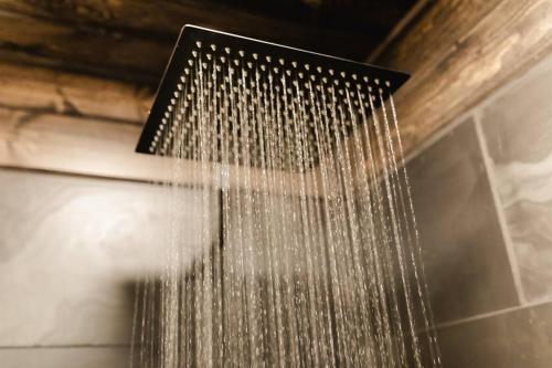 a shower with water coming out of it at Remodeled* Sleeps 7, Fire Pit, Indoor Bike Storage in Crosby