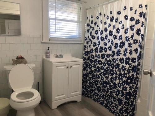 een badkamer met een toilet en een douchegordijn bij Lovely 1B1B Home in Heart of Pasadena in Pasadena