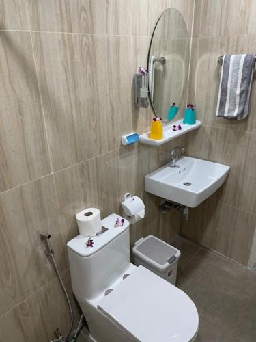 a bathroom with a toilet and a sink and a mirror at My Home in Patong Beach