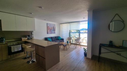a kitchen and living room with a table and chairs at Bello departamento en Bahia Inglesa con wifi y acceso quincho in Bahia Inglesa