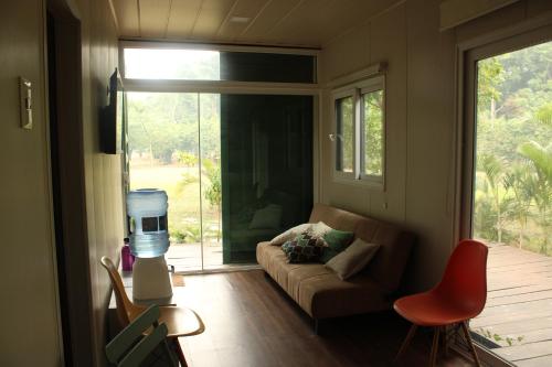 a living room with a couch and a large window at Relajate y disfruta in Santa Cruz de la Sierra