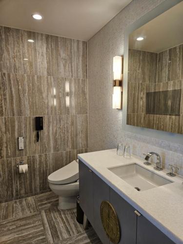 a bathroom with a toilet and a sink at LeoPalace Resort Guam in Yona