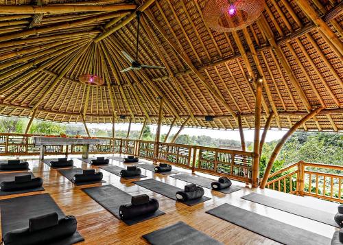 a room with a bunch of yoga mats in a building at Joyously Raw Villas - Free Room Upgrade Subject to Availability in Ubud