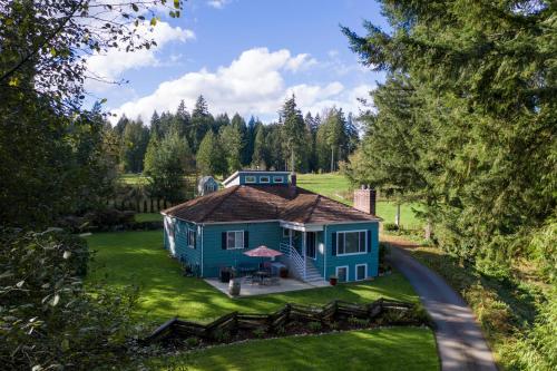 an aerial view of a blue house on a lawn at Rustic Chic Cottage near Mill Creek, Snohomish, Woodinville in Bothell